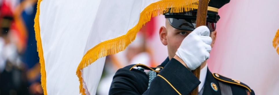 A service member carrying a flag