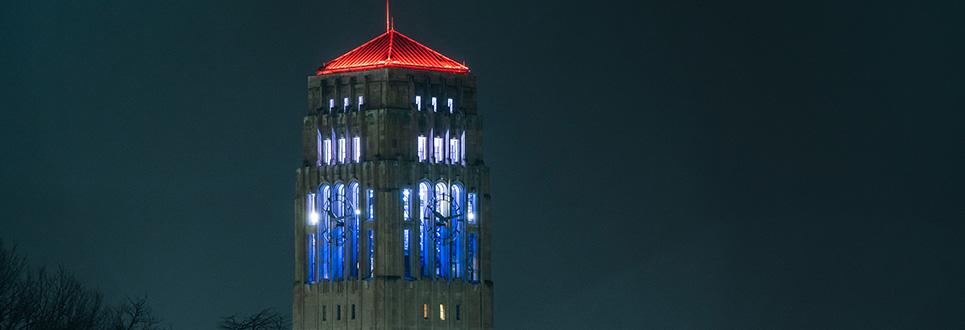 Burton Memorial Tower lit up in red, white, and blue
