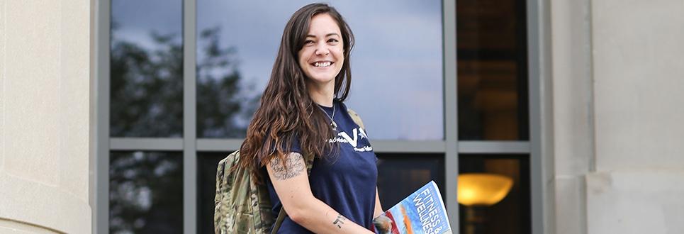 Student on the steps of Angell Hall