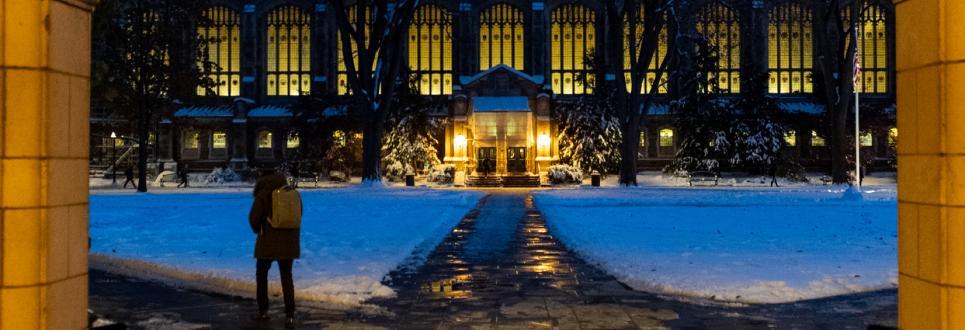 university building surrounded by snow at night