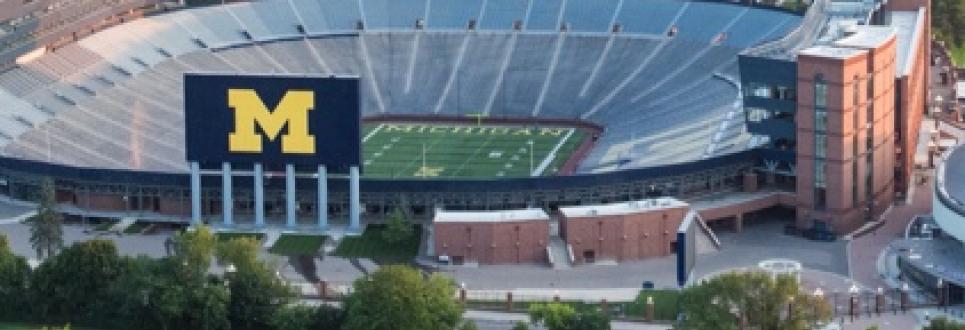 An aerial view of Michigan Stadium and Ann Arbor in the summer